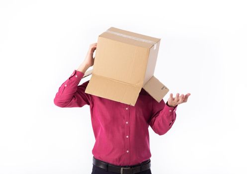 man in a red shirt with a cardboard box on his head makes a gesture with his hands