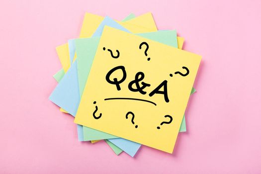 Sticky note Q & A on pink background
