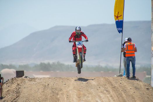 Off-road dirt bikes competing in a desert motocross rally