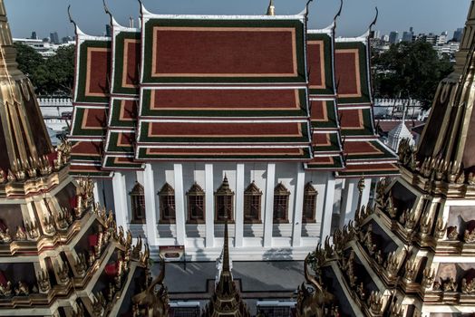 Symmetry view of Prasart Metal Palace beyond the Ratchanaddaram temple.