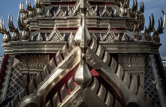 Symmetry view of Loha Prasart Metal Palace at Ratchanaddaram temple through the gate. Loha Prasat Metal Palace is famous tourist destination in Bangkok.