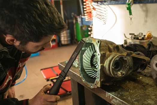 Mechanic repairs the gearbox