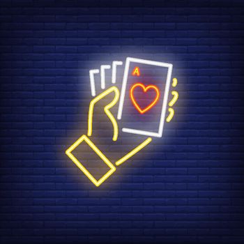 Hand holding ace cards neon sign