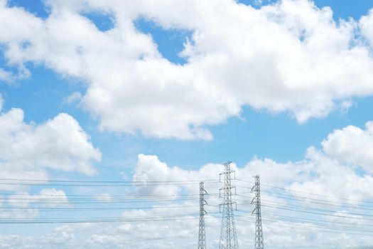 blue sky and white cloud with high voltage transmission towers and power line