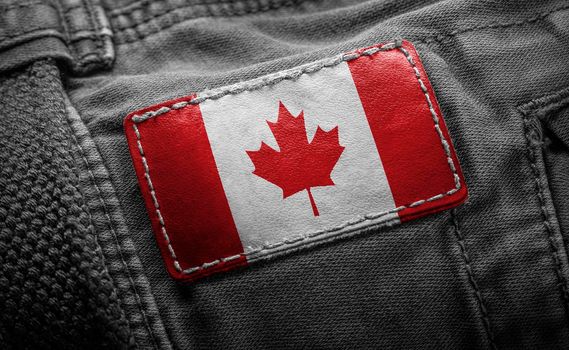 Tag on dark clothing in the form of the flag of the Canada