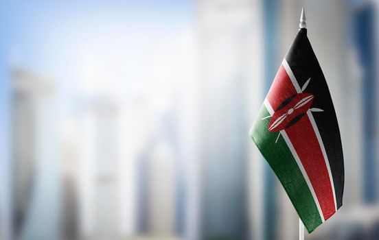 A small flag of Kenya on the background of a blurred background