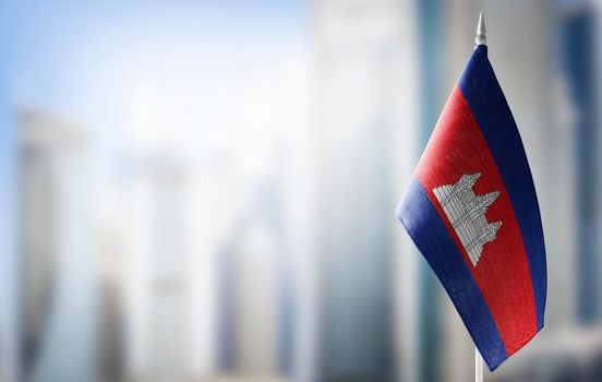 A small flag of Cambodia on the background of a blurred background