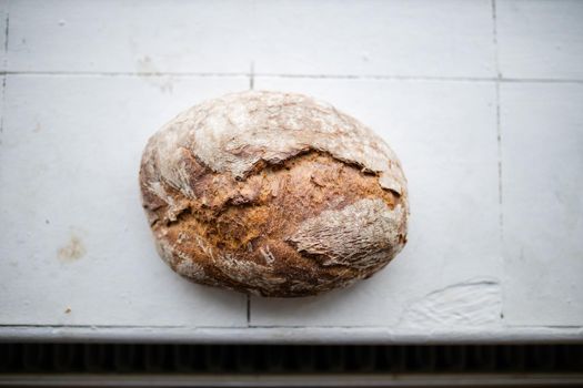 Sourdough bread on a white kitchen counter from above