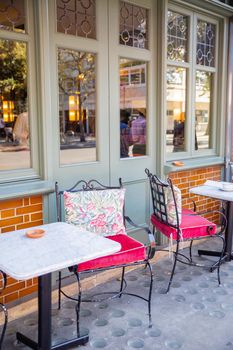 Comfy metal chairs and tables outside a British restaurant