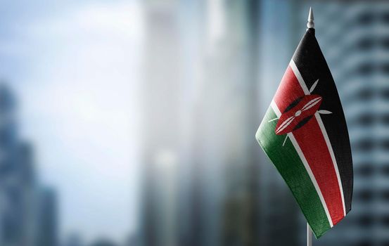 A small flag of Kenya on the background of a blurred background