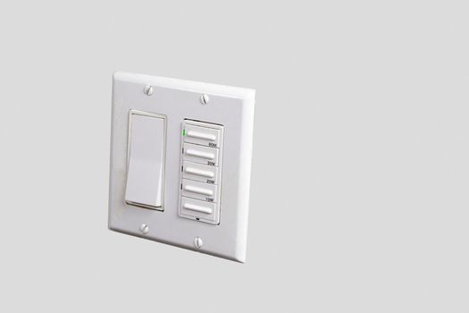 White light switch and fan relay on white wall