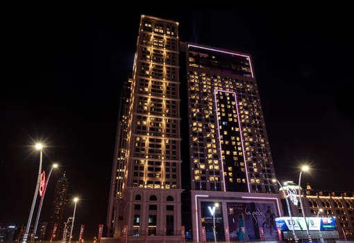 JAN 1ST ,2021, DUBAI UAE. The V hotel captured at night on the busy sheikh zayed road, Dubai, UAE. Long exposure photography. La Perle event hotel