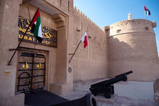 Feb 27th, 2021, Bur Dubai, UAE. View of the old Vintage door,canons and signboard at the entrance to the museum of Dubai UAE captured at Bur Dubai, UAE.