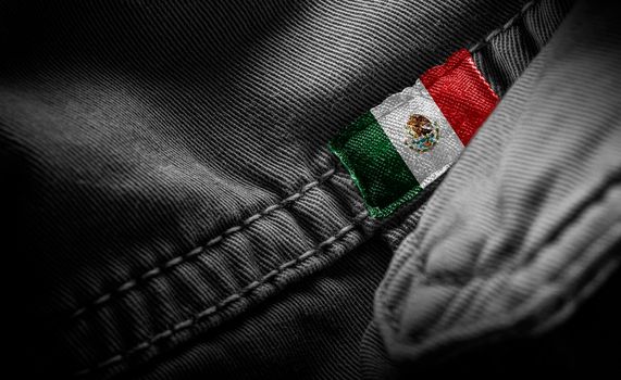 Tag on dark clothing in the form of the flag of the Mexico