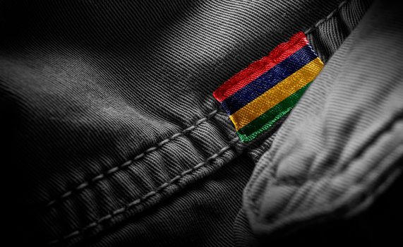 Tag on dark clothing in the form of the flag of the Mauritius