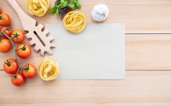 Italian foods concept and menu design . The ingredients for homemade pasta with copy space on wooden background.