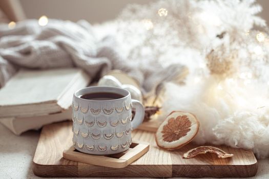 Home composition with beautiful cup on blurred cozy background.