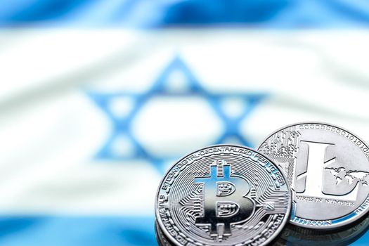 coins Bitcoin and litecoin, against the background of the Israeli flag, concept of virtual money, close-up. Conceptual image