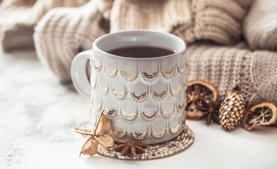 cozy winter composition with a cup and sweater