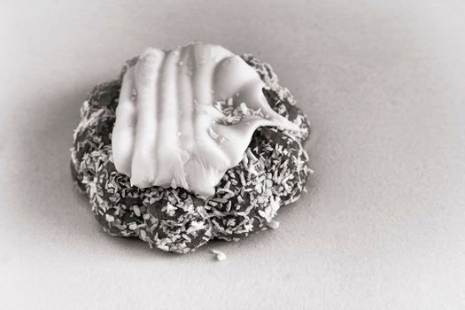 Delicious cookies covered with frosting and coconut. Black and white image.