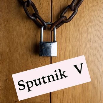 the wooden door closed with the chain and padlock at Sputnik V vaccine 