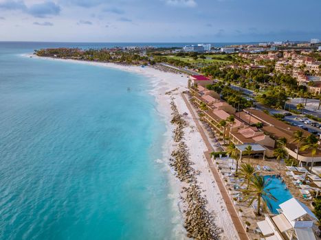 Aruba Caribbean white beach with palm trees and luxury swimming pool Aruba Caribbean