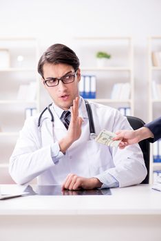 Doctor in corruption concept with being offered bribe