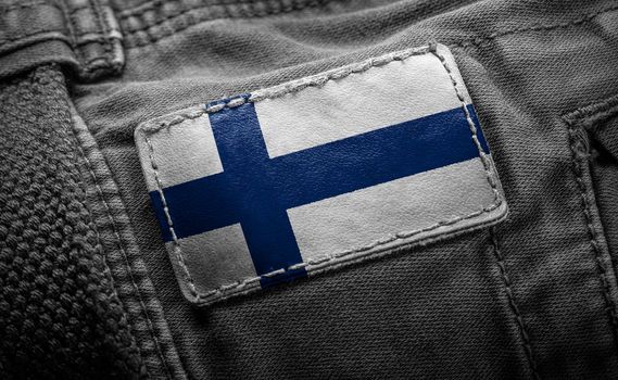 Tag on dark clothing in the form of the flag of the Finland