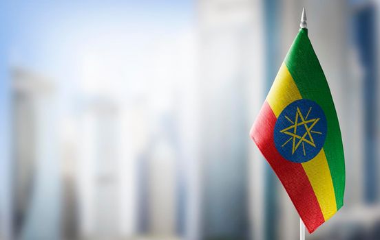 A small flag of Ethiopia on the background of a blurred background