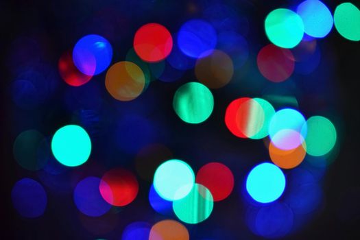 Color Abstract Blurred backgrounds - bokeh. Christmas lights on a pure black background. Preparing for the Holidays.