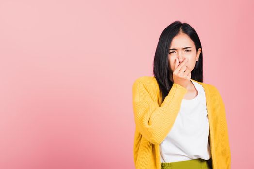 woman unhappy what a smell disgust expression squeezing nose with fingers