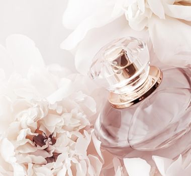Fragrance bottle as luxury perfume product on background of peony flowers, parfum ad and beauty branding