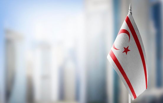 A small flag of Northern Cyprus on the background of a blurred background