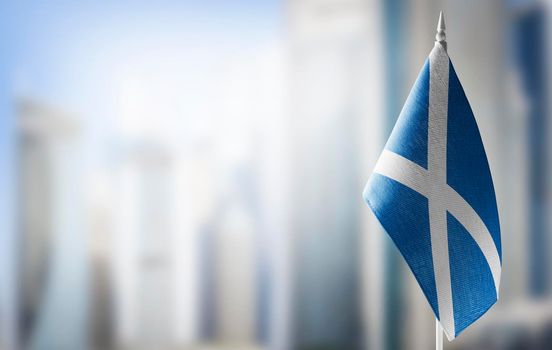 A small flag of Scotland on the background of a blurred background