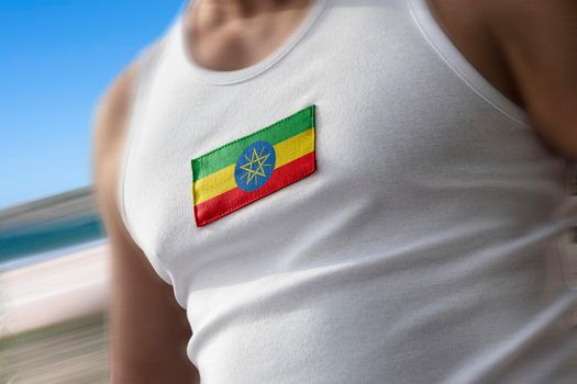 The national flag of Ethiopia on the athlete's chest