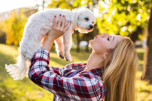 Woman  with her Maltese dog outdoor