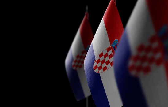 Small national flags of the Croatia on a black background
