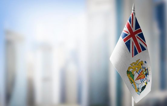 A small flag of British Antarctic Territory on the background of a blurred background