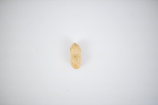 A peanut in shell isolated on white table