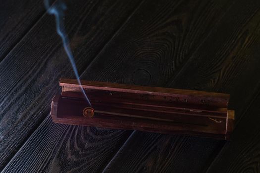 Focus on incense stick and smoke.