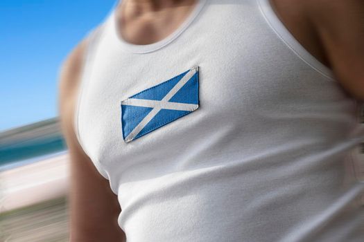 The national flag of Scotland on the athlete's chest