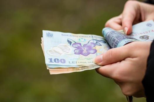 Selective focus on detail of LEI banknotes. Counting or giving Romanian LEI banknotes. World money concept, inflation and economy concept