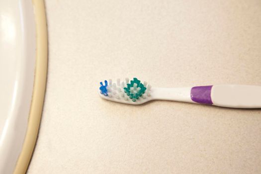 Toothbrush bristles and handle on countertop 
