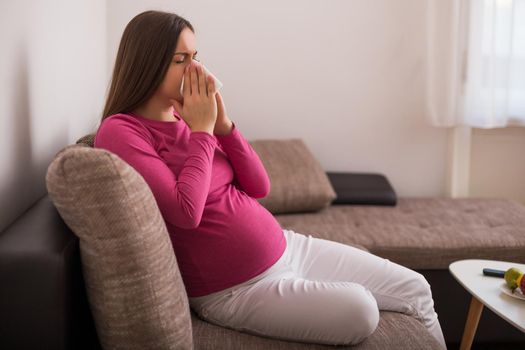 Pregnant woman  blowing nose