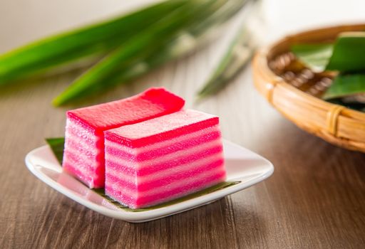 Kuih lapis is a traditional Malay nyonya sweet desert on wooden table