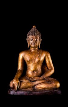 Image front side of antique gold buddha statue on black background. 