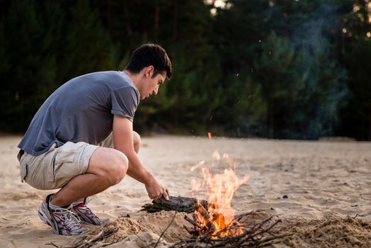 Man preparing campfire