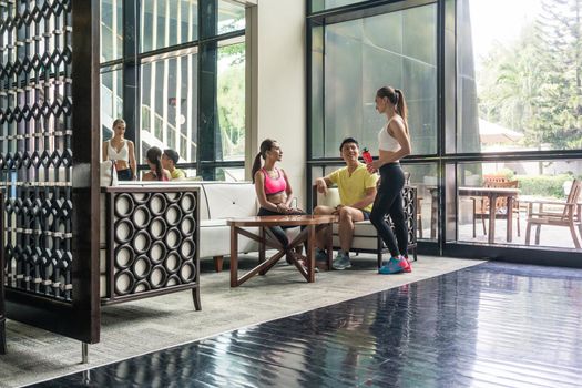 Young people socializing in the lounge area of a trendy health club