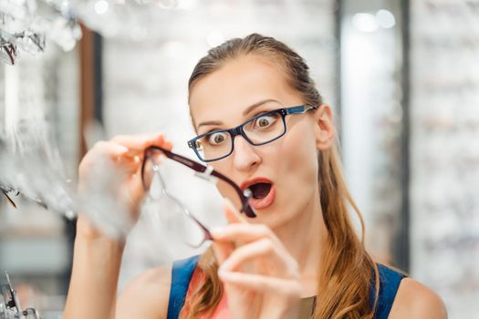 Woman loving the design of her new glasses almost too much