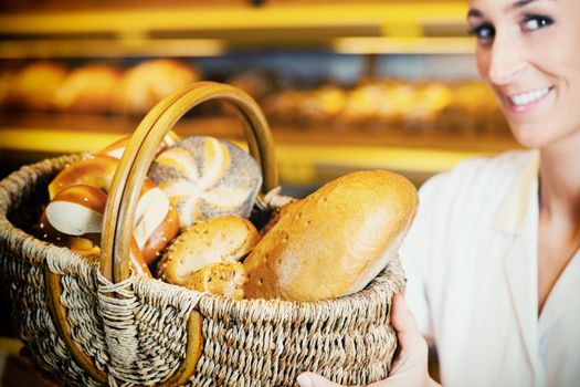 Baker woman in backer selling bread in basket